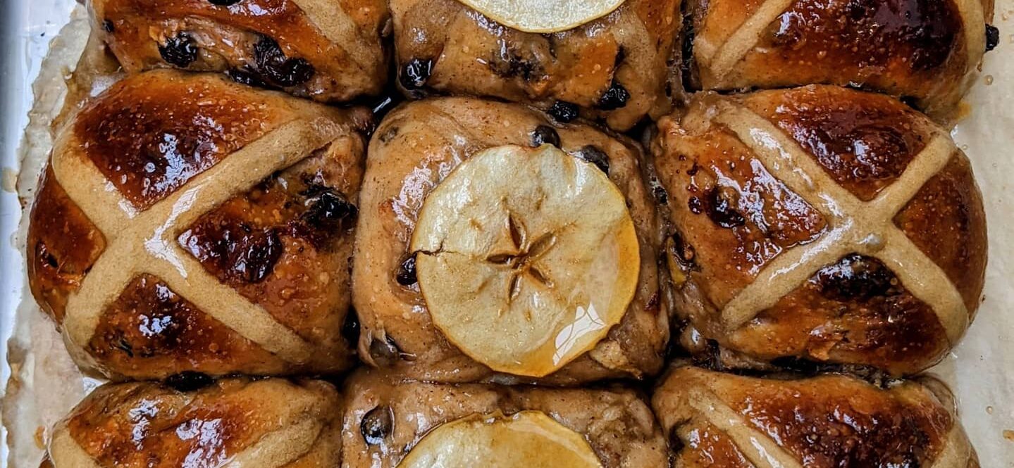 Sticky apple hot cross buns by plant-based bakery Heyl